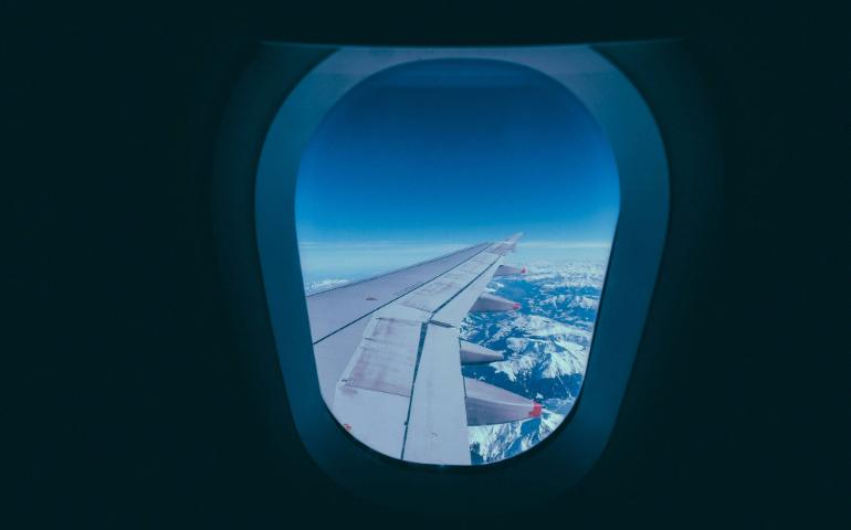 View of an aeroplane wing and snowy mountains through a window, ideal for travel themes.
Image Credit: Francesco Ungaro/Pexels