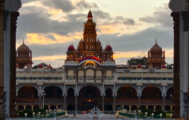 A beautiful view of Mysore Palace through an archway at sunset, showcasing intricate architecture.
Image Credit - Fx Ambro/Pexels