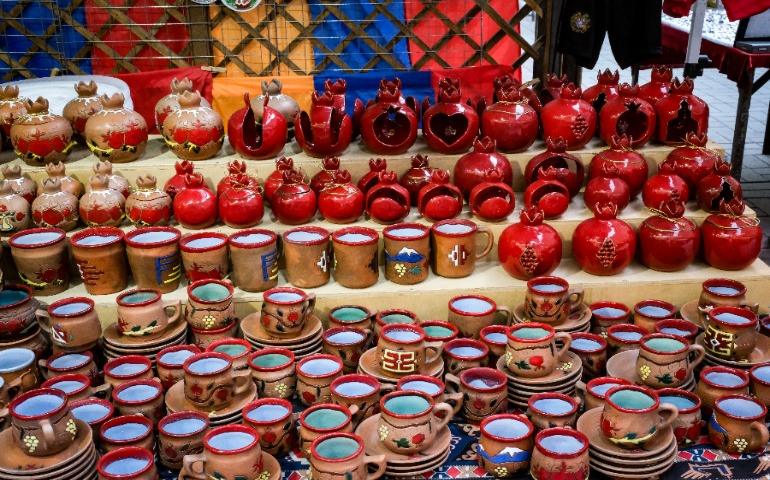Display of Armenian pottery featuring red pomegranate-shaped ceramics at a market stall.
Image credit: João Bomfim Junior/Pexels