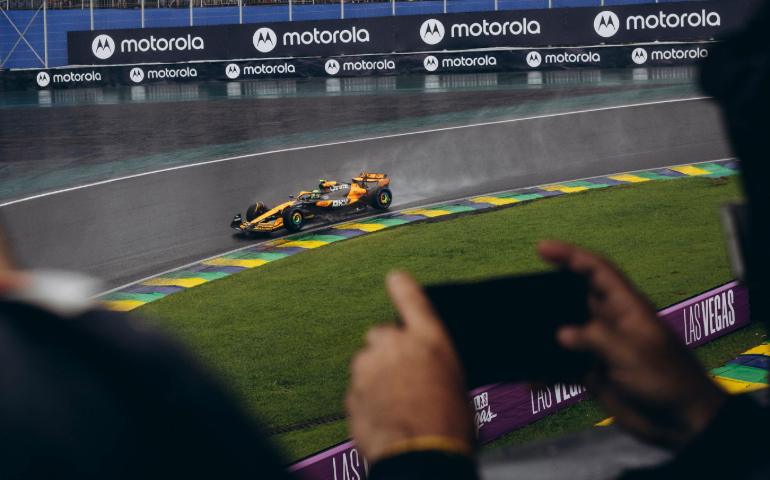 Scene of a Formula 1 car racing on a wet track surrounded by spectators
Image Credit: Jonathan Borba/Pexels