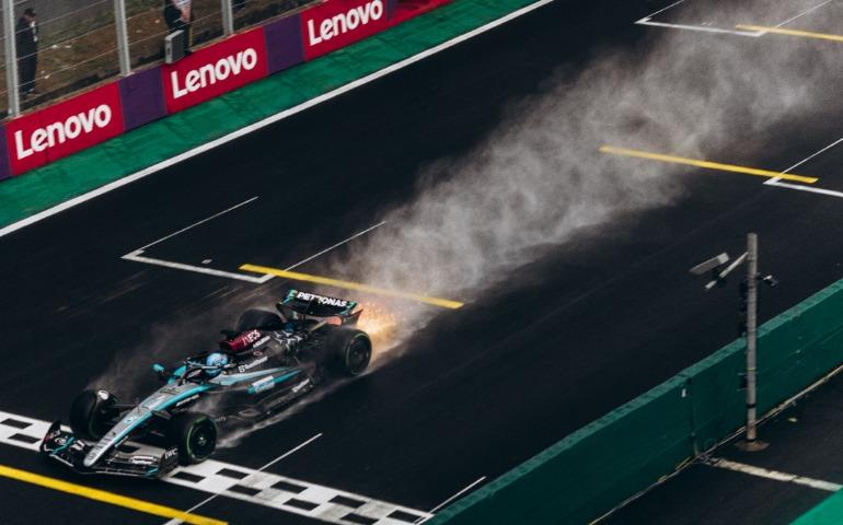 Dynamic shot of a Formula 1 car speeding across a wet track creating a spray of water
Image Credit: Jonathan Borba/Pexels