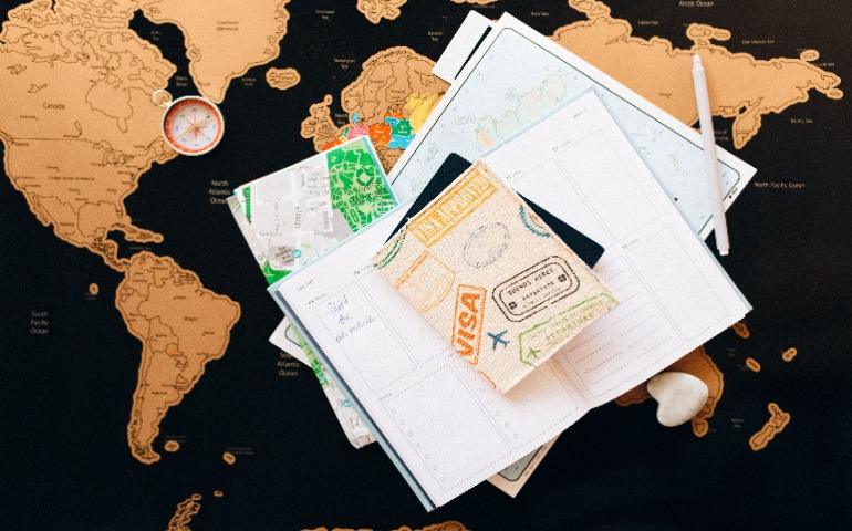 A flat lay of travel planning items on a map
Image Credit: Nataliya Vaitkevich/Pexels