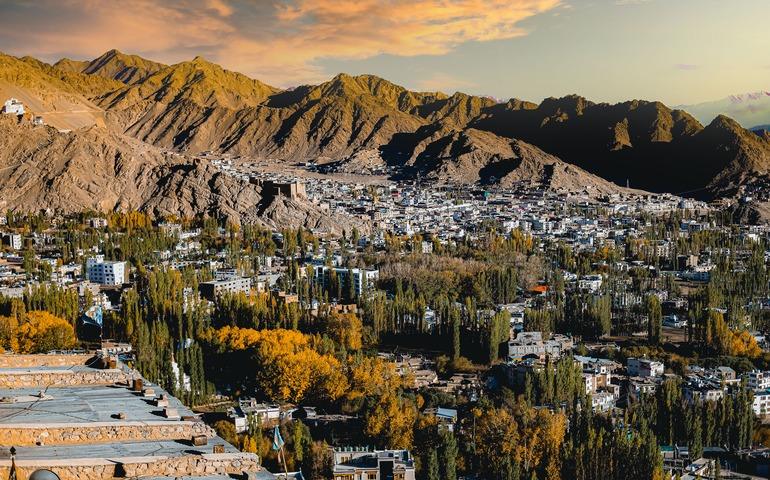 A stunning aerial view of Leh city surrounded by majestic mountains and colorful autumn foliage.
Image Credit - Nitin Flims/Pexels