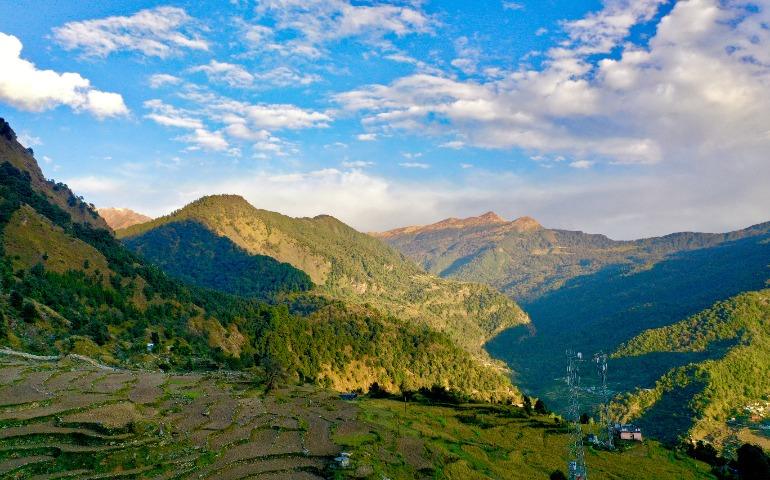 View of mountains and terraced fields in Chopta, India.