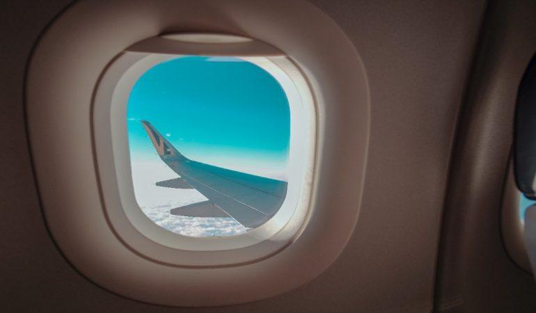 View of an airplane wing through a cabin window
Image Credit: Kai-Chieh Chan/Pexels
