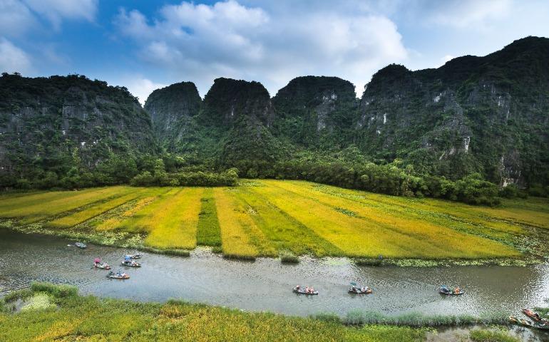 Landscape with lush fields, a river, and boats in Ninh Binh, Vietnam
Image Credit: Quang Nguyen Vinh/Pexels