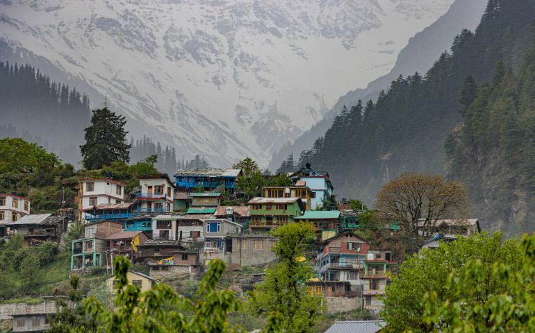 Scenic view of a colorful village in Manali with the snowy Himalayas in the background.
Image Credit - Shantum Singh/Pexels