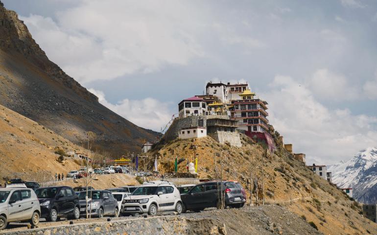 Picturesque view of Key Monastery atop a hill in Spiti Valley, with cars and mountains.
Image Credit - Mustafa Fatemi/Pexels