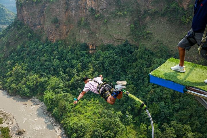 Experience the adrenaline rush of bungee jumping over a scenic canyon with dense greenery.
Image Credit: The Duluwa🇳🇵
