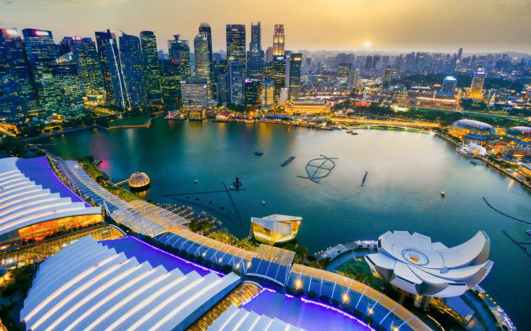 Stunning aerial shot of Singapore's cityscape during sunset with vibrant lights and architecture.
Image Credit: Towfiqu barbhuiya/Pexels