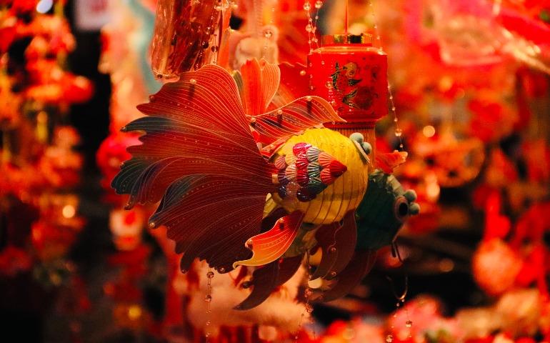 Brightly colored traditional lanterns hang in a festive display.
Image Credit: Tuan Vy/Pexels