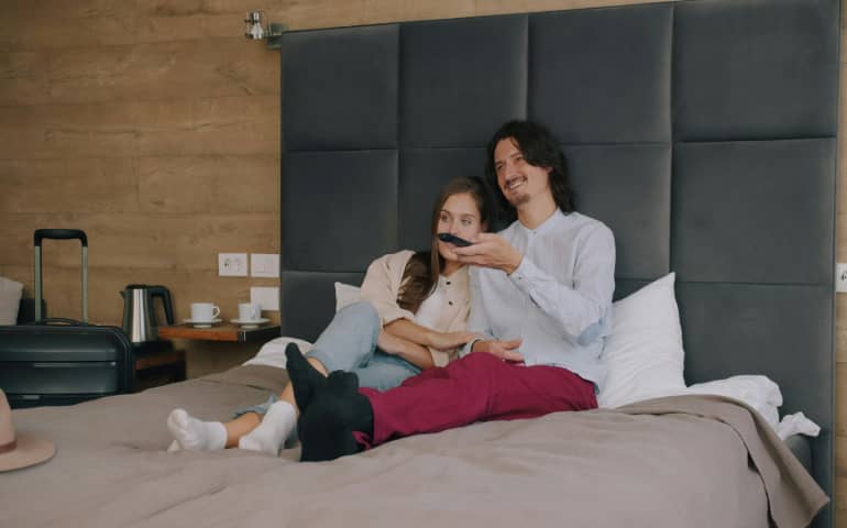 A couple relaxing in their hotel room