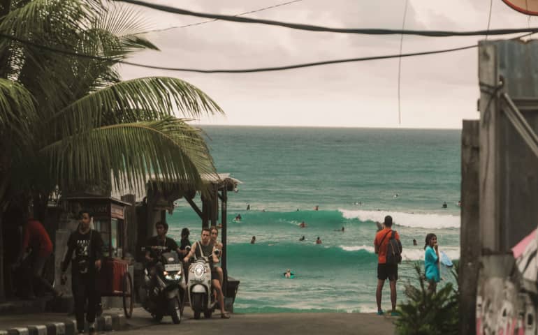 People enjoying the weather near the beach
