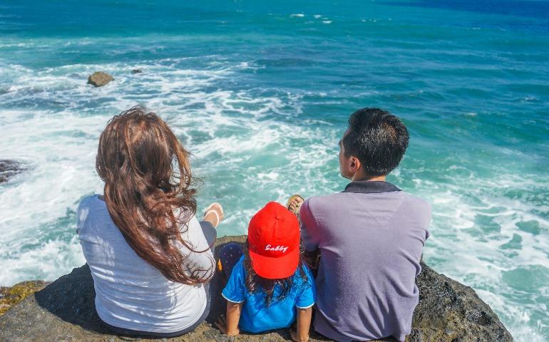 Beautiful family looking into the ocean
Image Credit: Devon Daniel/Unsplash