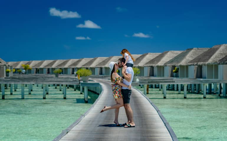 A couple with their child in Maldives