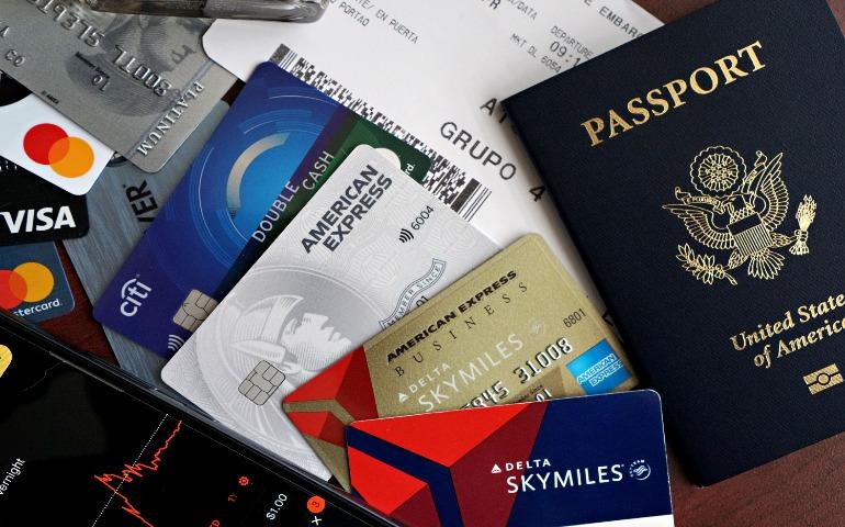Travel essentials including a passport, credit cards, and a boarding pass.
Image Credit: DΛVΞ GΛRCIΛ/Pexels
