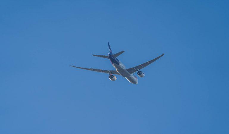 A passenger airplane flying high in a clear blue sky, viewed from below
Image Credit: Frank Grün/Pexels