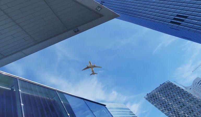 View of an aeroplane flying over modern skyscrapers
Image Credit: Jan Habarta/Pexels
