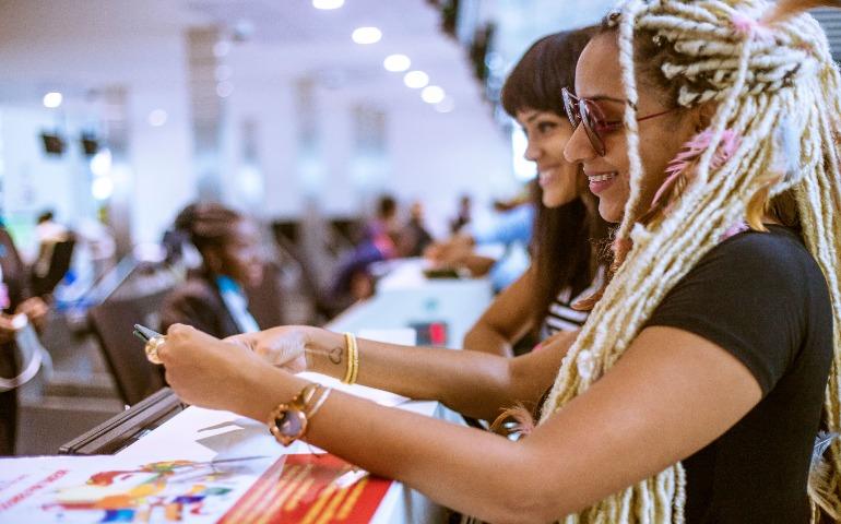 Women Smiling Woman smiling while looking at a ticket.
Image Credit: Jeffrey Paa Kwesi Opare/Pexels