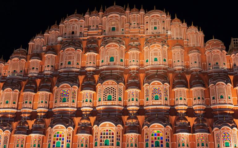 Iconic Hawa Mahal's illuminated facade in Jaipur, showcasing intricate architecture and vibrant colors.
Image Credit: Kashvi Shah/Pexels