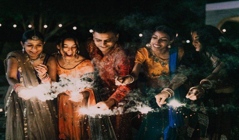 A group of friends enjoying Diwali night with sparklers in traditional clothing.
Image Credit: RDNE Stock project/Pexels