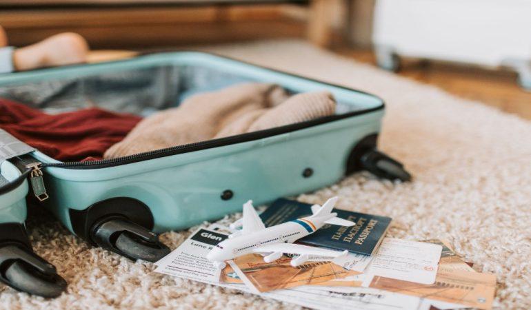 Open suitcase with travel essentials like passport and tickets
Image Credit: Vlada Karpovich/Pexels